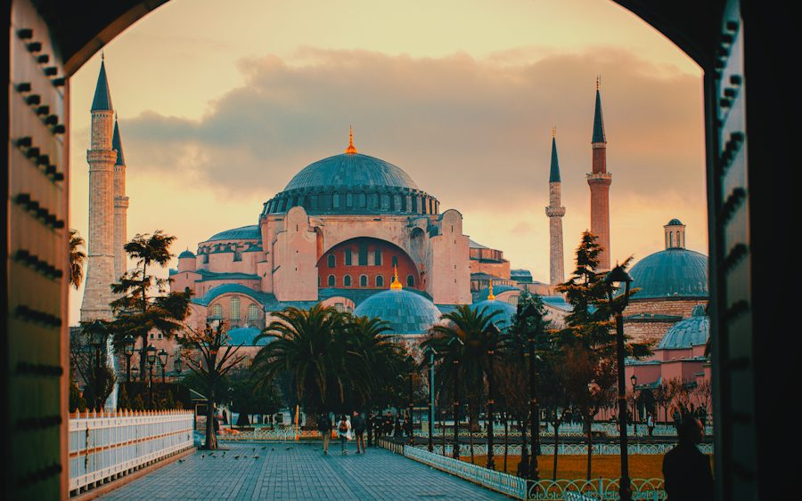 Hagia Sophia framed by a stone archway in golden light