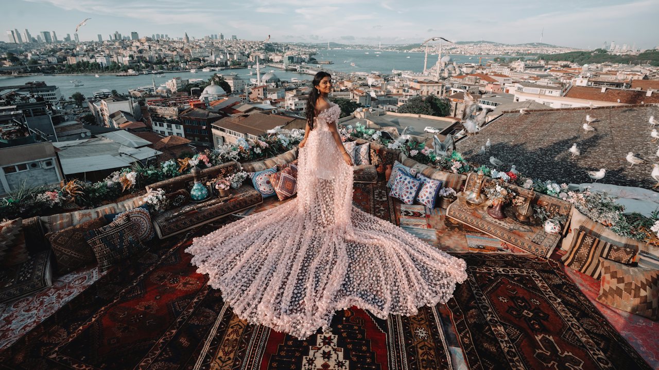 Model in a flowing gown on an Istanbul rooftop above the Golden Horn